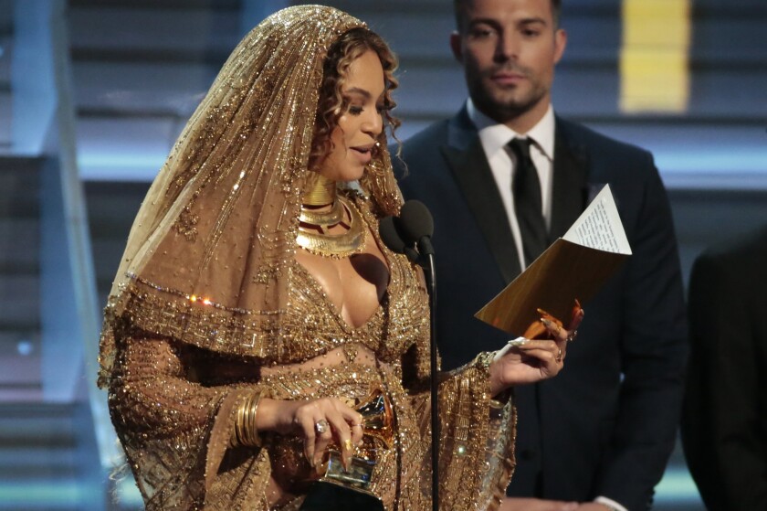 Singer Beyoncé reads her Grammy acceptance speech Sunday, during which she said that her "Lemonade" album had been created in part for her children.