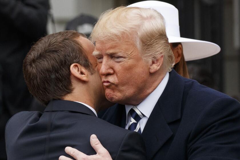 President Donald Trump greets French President Emmanuel Macron as he arrives for a State Arrival Ceremony on the South Lawn of the White House in Washington, Tuesday, April 24, 2018. (AP Photo/Carolyn Kaster)
