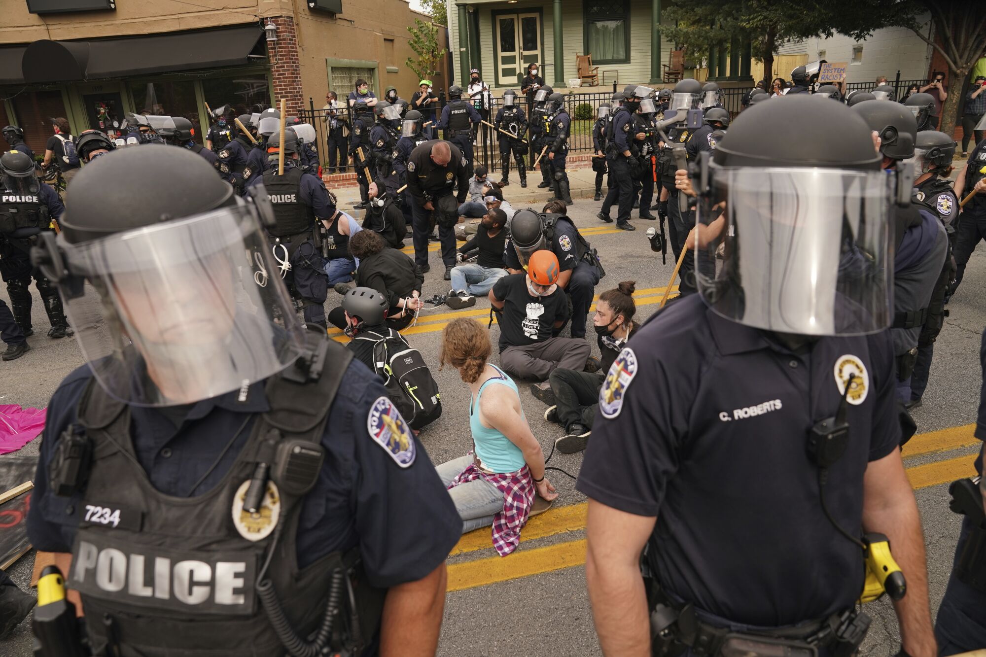 Police detain protesters in Louisville. 