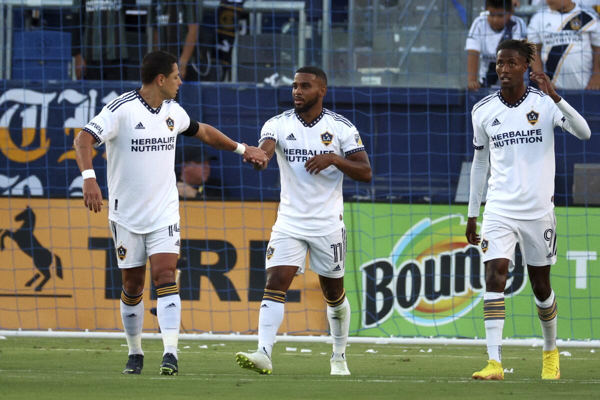 Galaxy midfielder Samuel Grandsir celebrates with forward Javier Hernández.