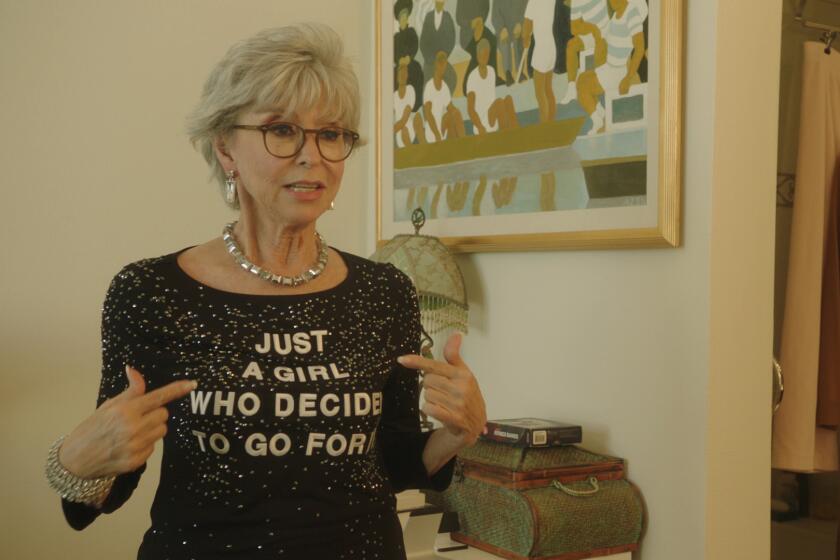 Rita Moreno wears a T-shirt emblazoned with the words "Just a Girl Who Decided to Go for It.”