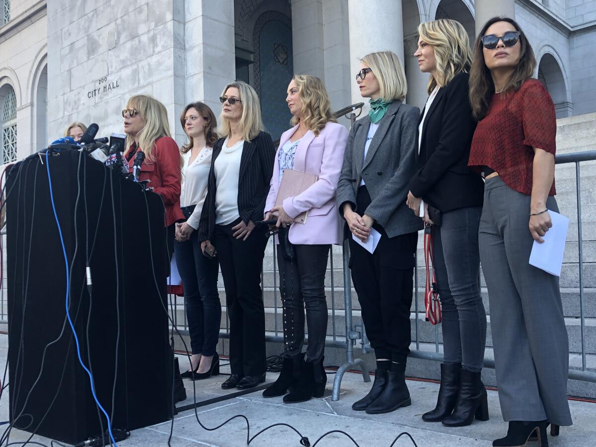 On the morning after Harvey Weinstein's conviction in Manhattan, actress Rosanna Arquette stands with 11 other women who have accused the producer of sexual assault at a press conference at Los Angeles City Hall.