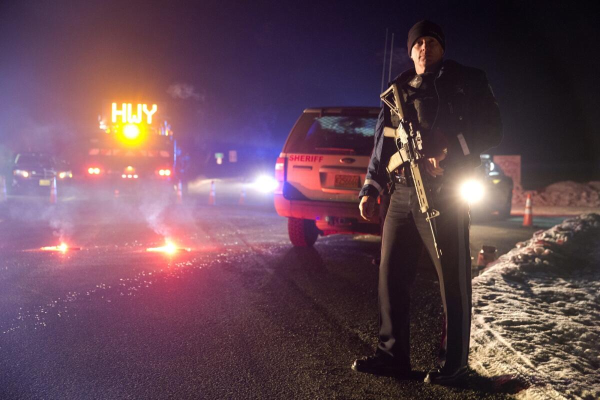 Sgt. Tom Hutchison stands in front of an Oregon State Police roadblock on U.S. 395 between John Day and Burns.