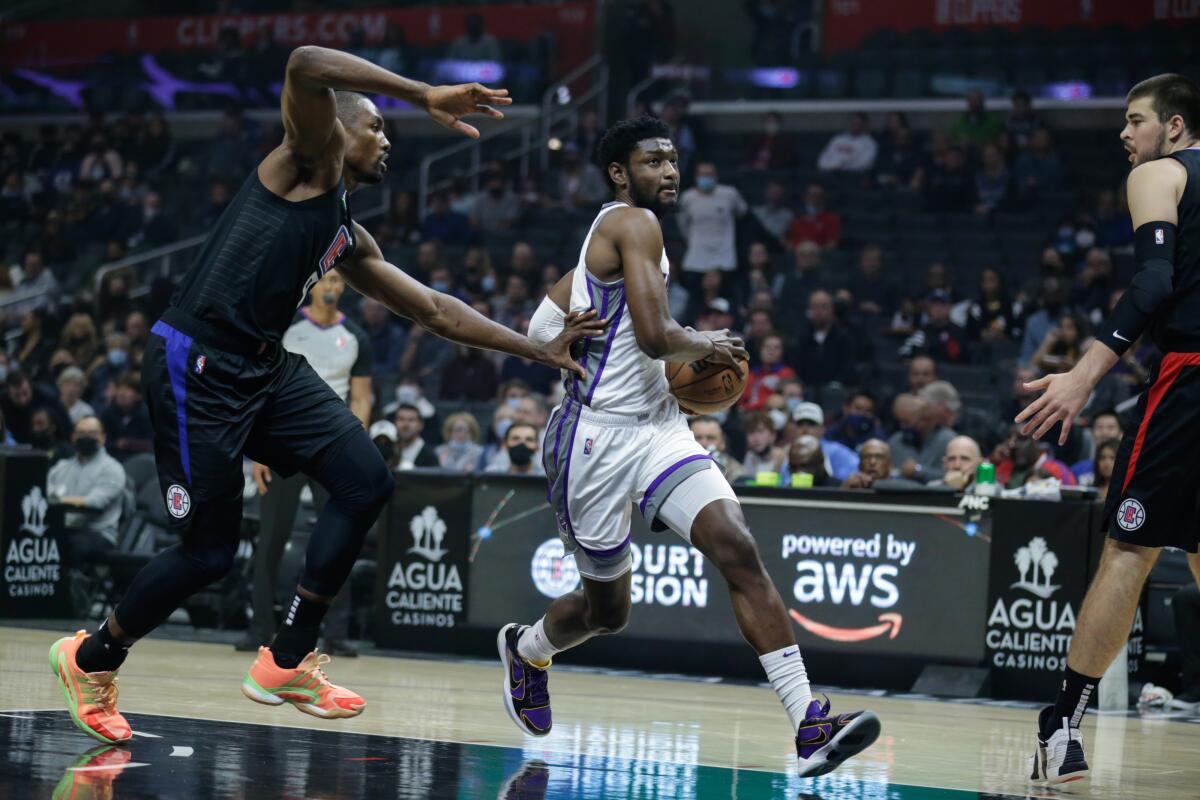 Sacramento Kings forward Chimezie Metu drives on Clippers center Serge Ibaka.