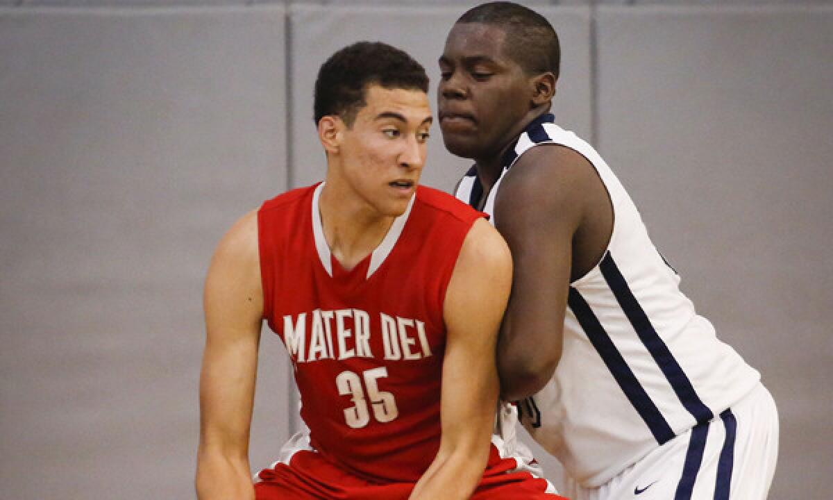 Mater Dei sophomore M.J. Cage, left, is guarded by Mayfair junior Kendall Smith during a Southern Section Open Division playoff game in February. Cage will continue to play a key role for Mater Dei next season.