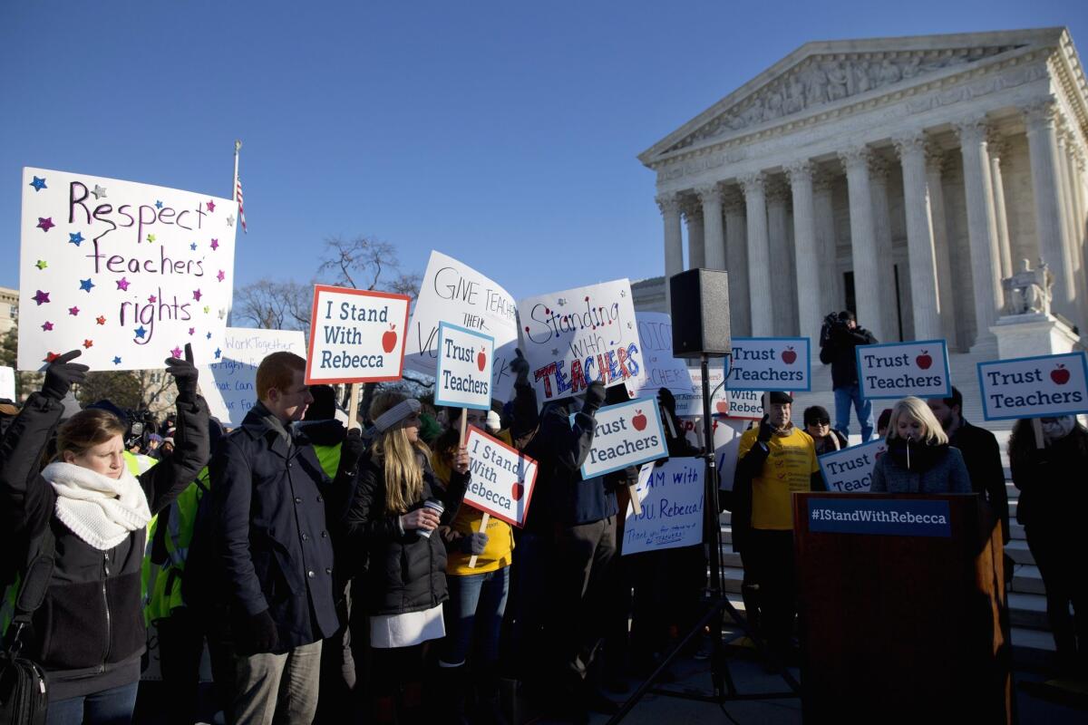 People rally at the Supreme Court as justices hear arguments in Friedrichs vs. California Teachers Assn.