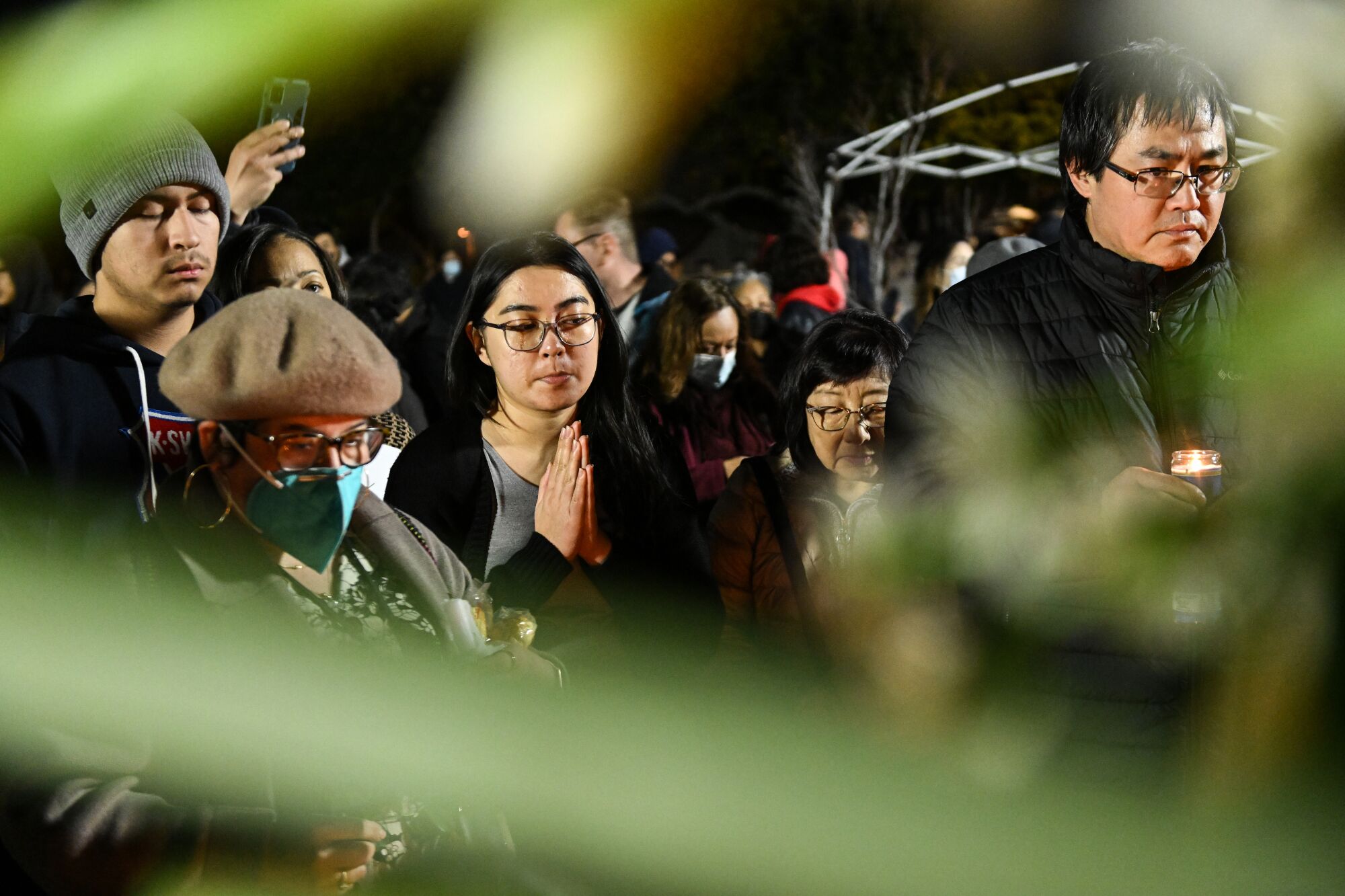 Mourners participate in a vigil in Monterey Park.