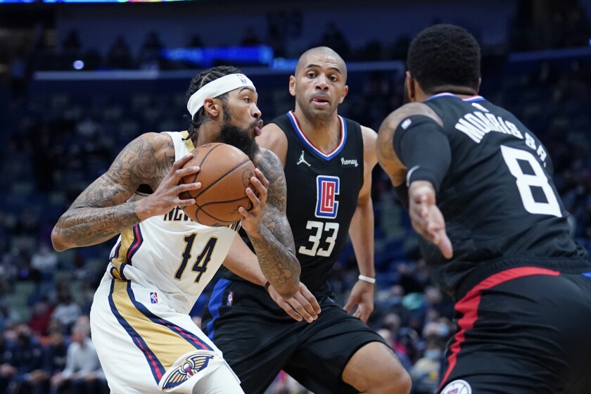 Brandon Ingram drives to the basket against Clippers forwards Nicolas Batum and Marcus Morris Sr.