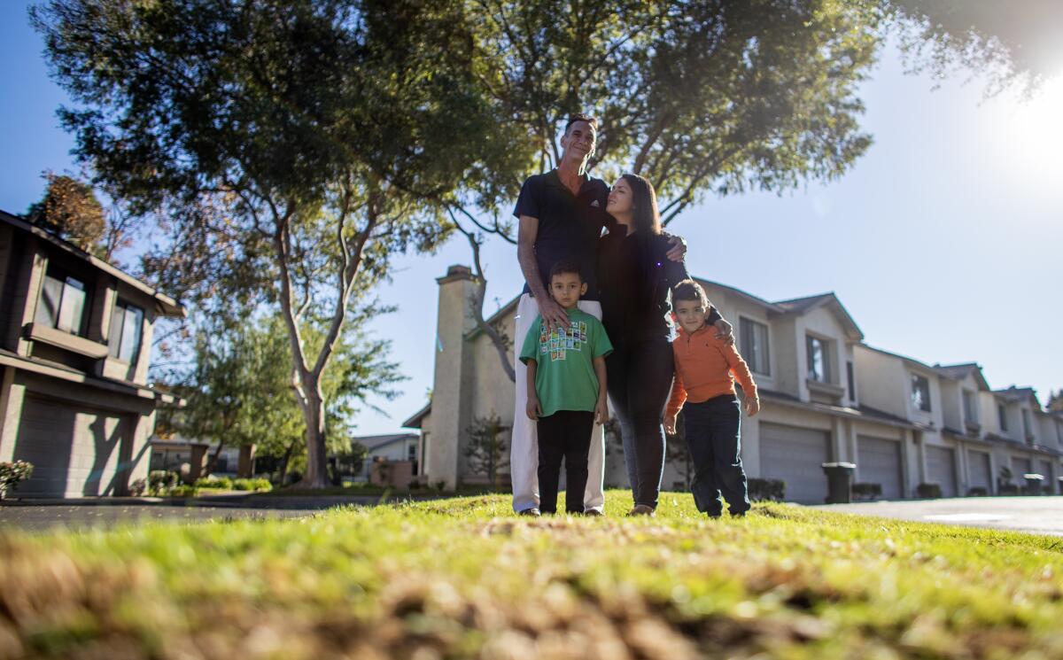 A family stands on a median at their housing complex in Anaheim