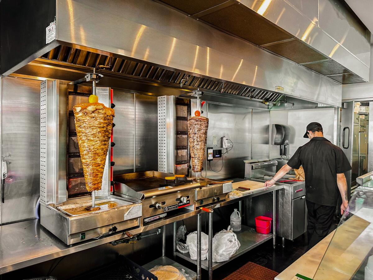 The shawarma spits behind the counter inside Sincerely Shawarma.