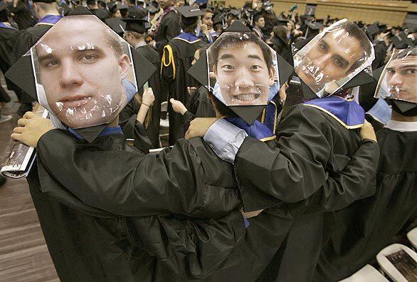 From left, UCLA students Austin Henderson, Ken Fukada and Woody Strassner, all 22, and Bobbak Sabet, 21, display headshots on their graduation caps so their family and friends in the seats above can find them more easily at the graduation ceremony for the College of Letters and Science at Pauley Pavilion. About 4,100 graduates participated.