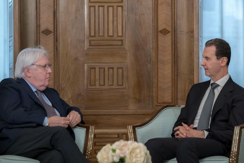 In this photo released on the official Facebook page of the Syrian Presidency, Syrian President Bashar Assad meets with Martin Griffiths, United Nations Under-Secretary-General for Humanitarian Affairs, left, in Damascus, Syria, Monday, Feb. 13, 2023. Griffiths also met with Syrian Foreign Minister Faisal Mekdad Monday to discuss ways to get aid to all parts of Syria following the deadly earthquake that hit Turkey and Syria last week. (Syrian Presidency Facebook page via AP)