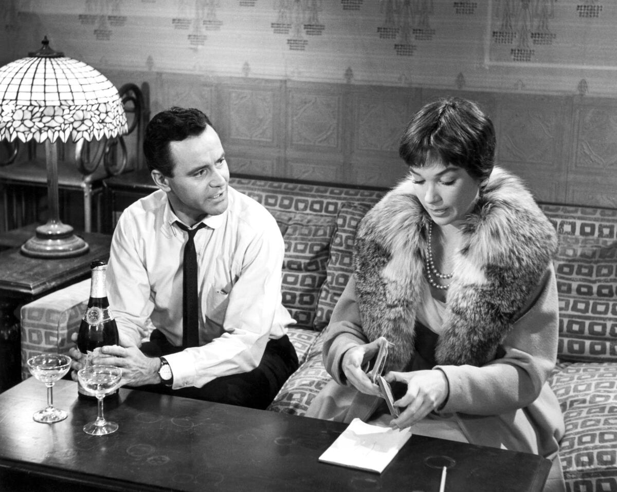 black and white photo of a man and woman on a couch 