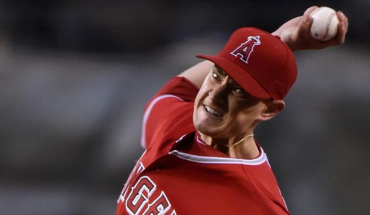 Angels starter Garrett Richards tenses up as he delivers a pitch in the second inning against the Padres.