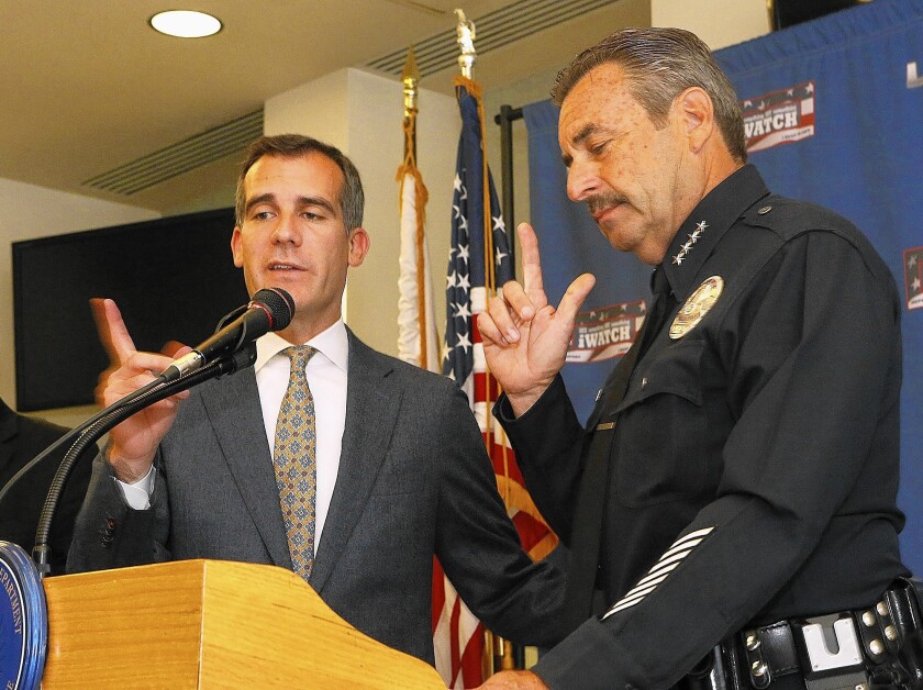 Los Angeles Mayor Eric Garcetti, left, and LAPD Chief Charlie Beck announce a rise in violent crime, driven by a 12% increase in aggravated assaults, during the first half of this year.