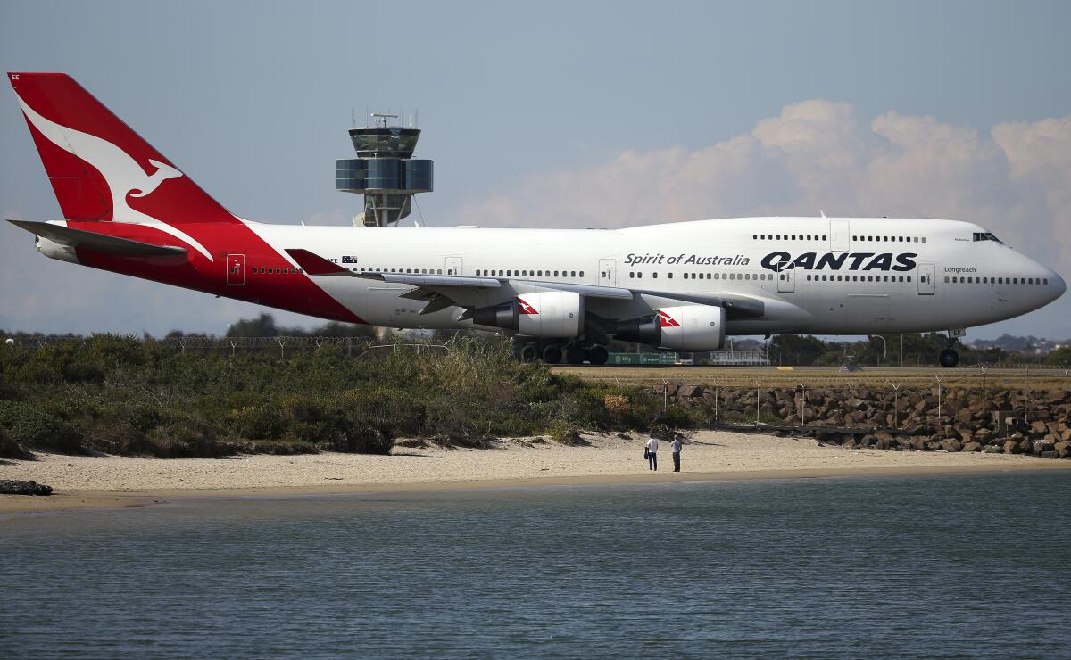 Qantas airliner taxiing on airport runway