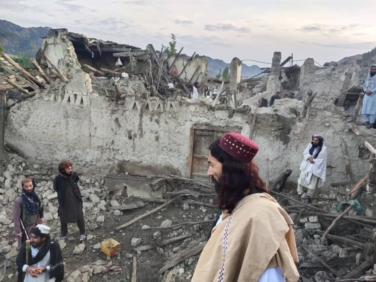 Afghans look at destruction caused by an earthquake