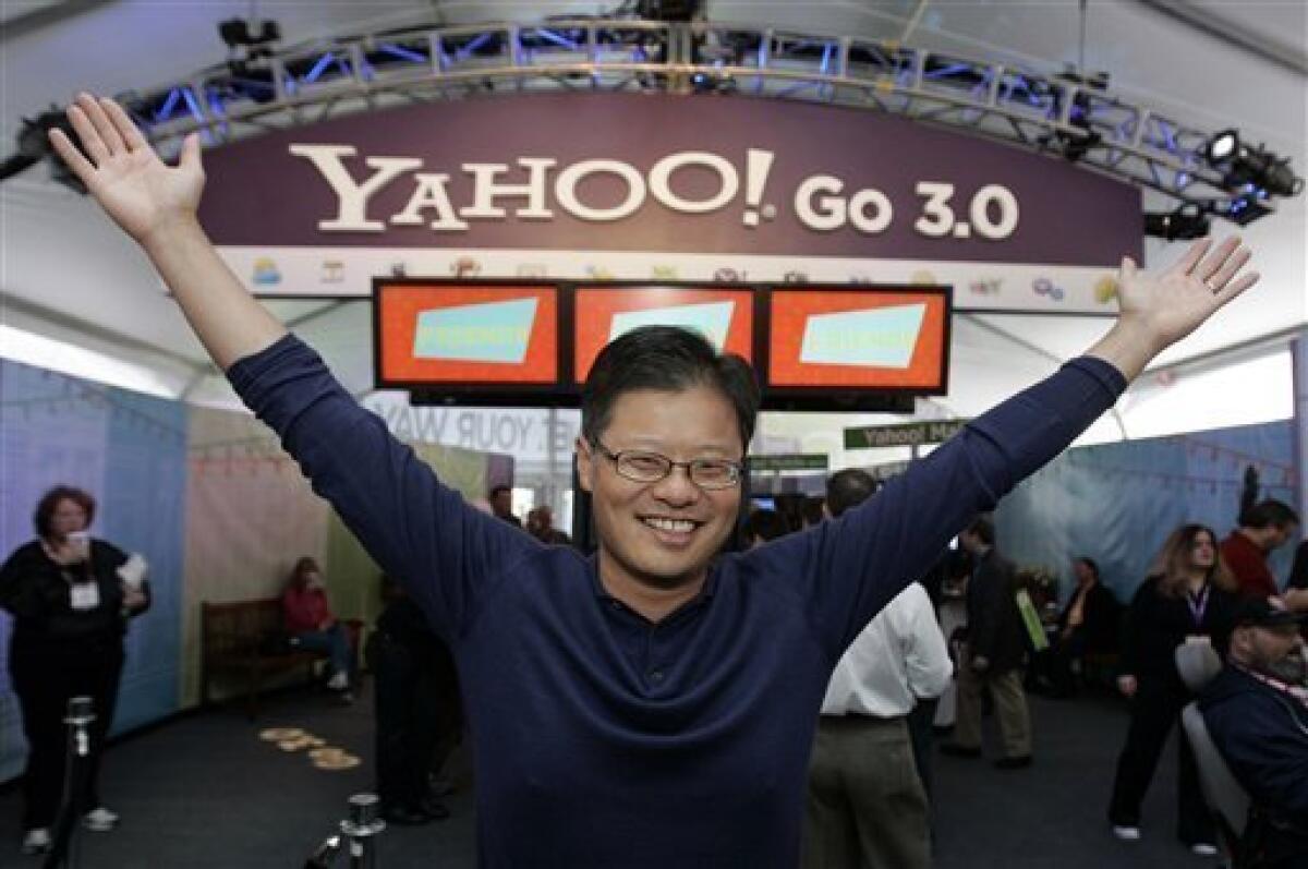 FILE - In this Jan. 7, 2008 file photo of Yahoo CEO Jerry Yang gestures in the Yahoo booth after he gave his keynote address at the Consumer Electronics Show (CES) in Las Vegas. Yang announced Tuesday, Jan. 17, 2012, that he is leaving Yahoo. The surprise departure comes just two weeks after Yahoo Inc. hired former PayPal executive Scott Thomson as its CEO. Yang expressed his support of Thompson in his resignation from Yahoo's board of directors. He had been on Yahoo's board since the company's 1995 inception. (AP Photo/Paul Sakuma, File)