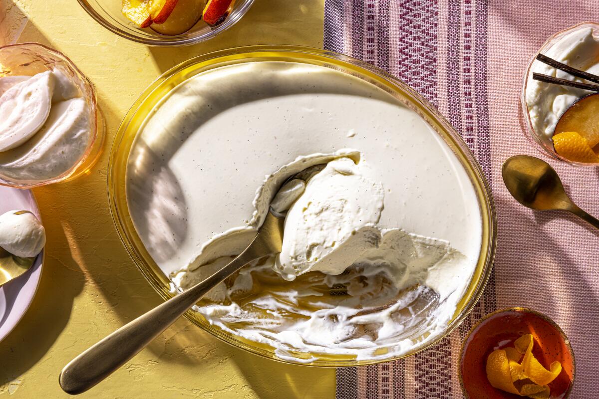 Closeup of a glass dish with creamy dessert that's been scooped out.