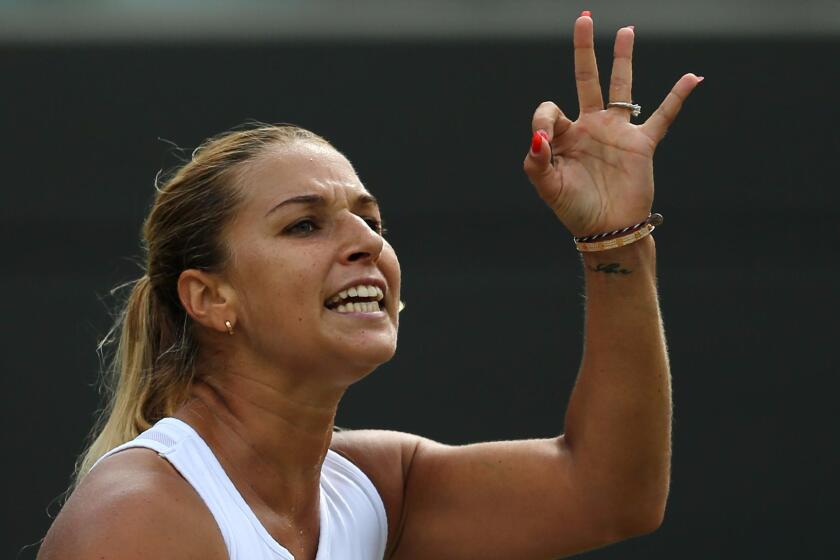 Slovakia's Dominika Cibulkova reacts after losing a point to Russia's Elena Vesnina during their women's singles quarterfinal match on the ninth day of the Wimbledon Championships.