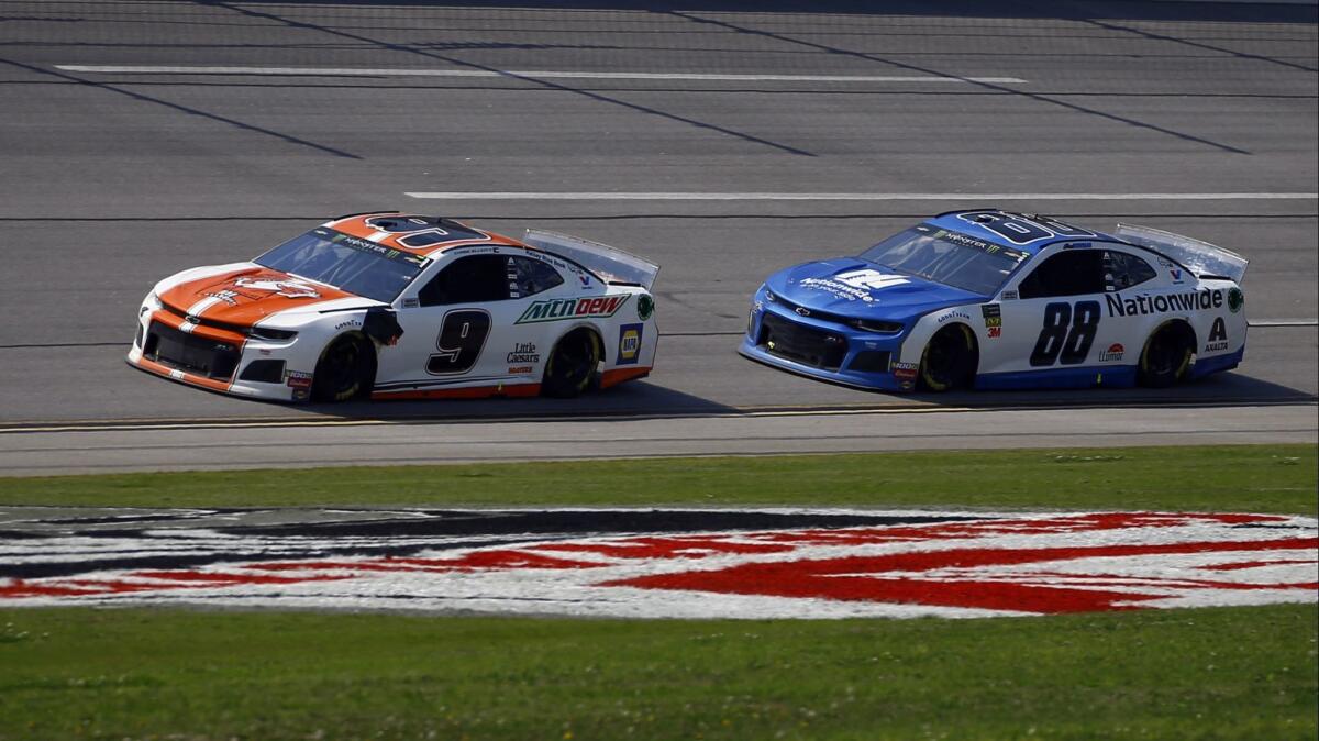 Chase Elliott, left, races ahead of Alex Bowman at Talladega Superspeedway on April 28.