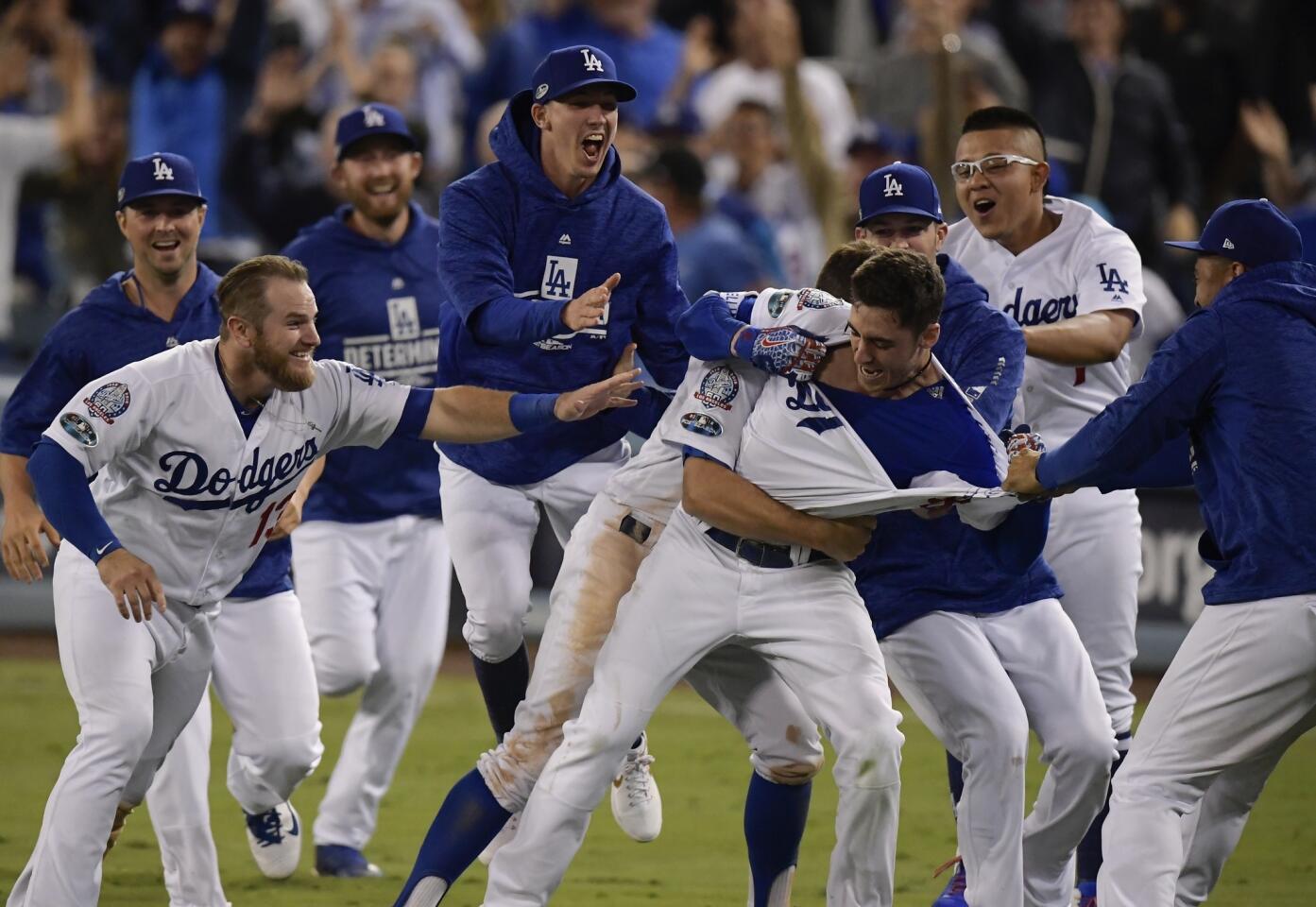 Los Angeles Dodgers' Cody Bellinger celebrates after hitting a walk-off hit during the 13th inning of Game 4 of the National League Championship Series baseball game against the Milwaukee Brewers Tuesday, Oct. 16, 2018, in Los Angeles. The Dodgers won 2-1 to tie the series at 2-2. (AP Photo/Mark J. Terrill)