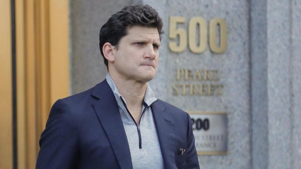 Gordon Caplan of Greenwich, Conn., walks out of federal court Tuesday in New York.