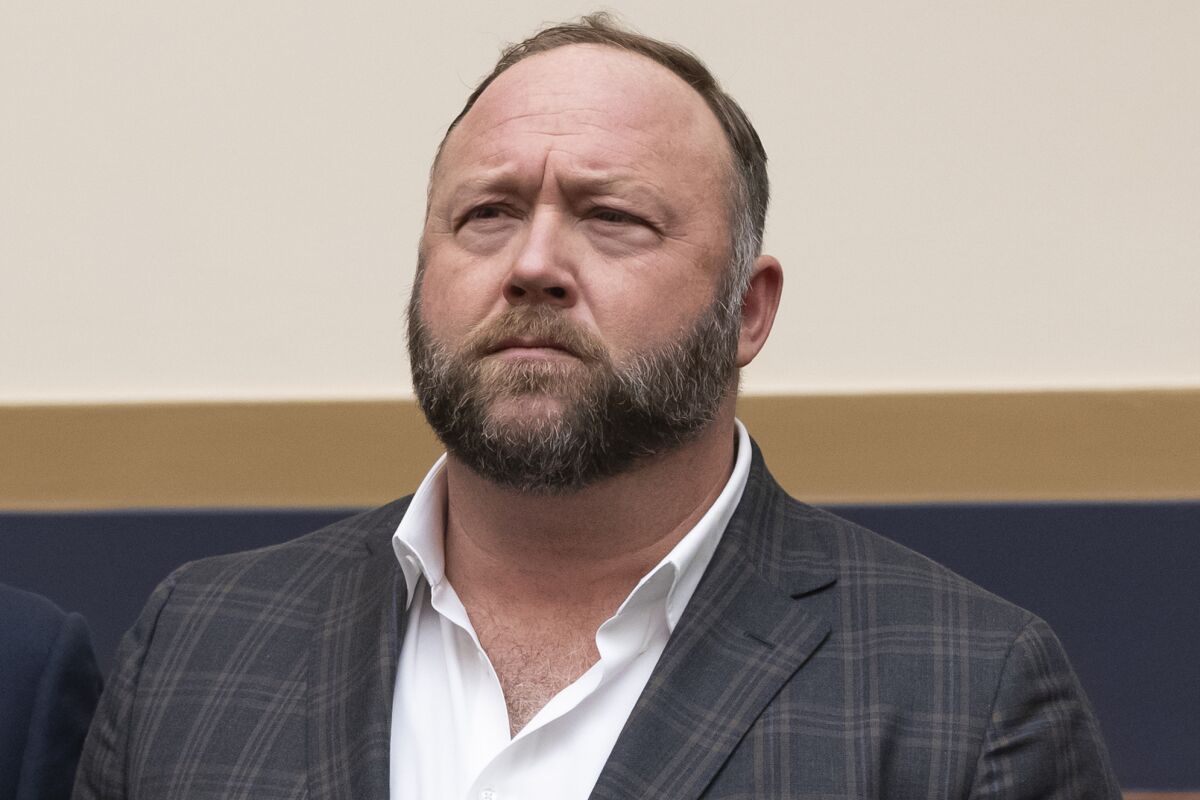 FILE - This Tuesday, Dec. 11, 2018, photo shows radio show host and conspiracy theorist Alex Jones at Capitol Hill in Washington. Jones was being questioned Wednesday, April 6, 2022, by lawyers for families of Sandy Hook Elementary School victims in Connecticut, where a judge had ordered the Infowars host to face mounting fines until he appeared for a deposition. (AP Photo/J. Scott Applewhite, File)