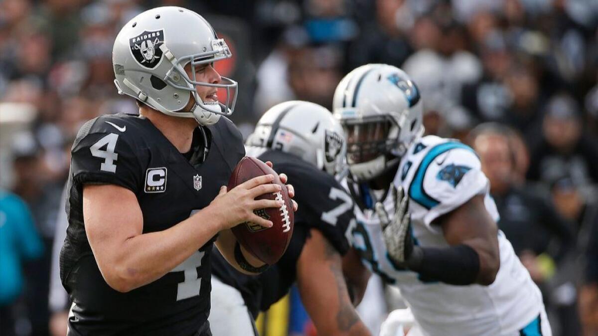 Raiders quarterback Derek Carr looks to throw against the Panthers during the first half of a game on Nov. 27.