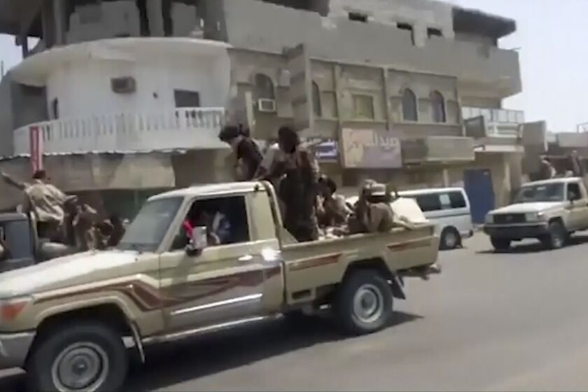 In this frame grab from video provided by Yemen Today, Yemeni army vehicles enter Zinjibar, Yemen, Wednesday, Aug. 28, 2019. Yemeni officials and local residents say forces loyal to the country's internationally recognized government have wrested control of the capital of southern Abyan province from separatists backed by the United Arab Emirates. They say government forces on Wednesday pushed the UAE-backed militia, known as the Security Belt, out of Zinjibar after clasher that left at least one dead and 30 wounded fighters. (Yemen Today via AP)