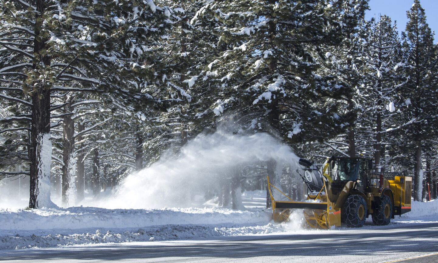 A plow removes snow from state Highway 203 in Mammoth Lakes.