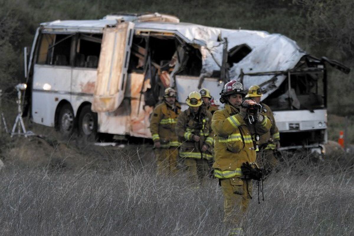 San Bernardino County fire captain Bryant O'Hara armed with a thermal imaging device scour the accident scene on Monday morning. Investigation continues at the scene of a tour bus crash happened on last Sunday evening on Highway 38 that killed at least eight to 10 people and 15 suffered life-threatening injuries just north of Yucaipa.