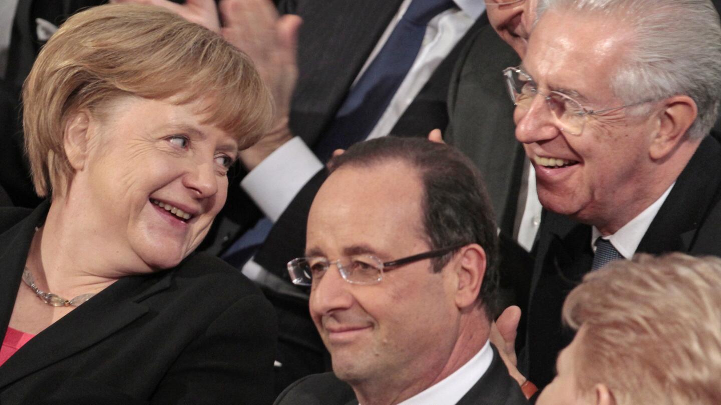 German Chancellor Angela Merkel talks with Italy's Prime Minister Mario Monti, right, and French President Francois Hollande during a ceremony in Oslo, Norway, in 2012. The European Union received the award for promoting "peace and reconciliation, democracy and human rights" in Europe.