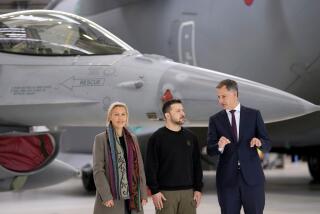 FILE - Belgium's Prime Minister Alexander De Croo, right, and Belgium's Defense Minister Ludivine Dedonder, left, pose with Ukraine's President Volodymyr Zelenskyy in front of an F-16 at Melsbroek military airport in Brussels, on May 28, 2024. Ukraine may keep some of the F-16 fighter jets it's set to receive from its Western allies at foreign bases to protect them from Russian strikes, a senior Ukrainian military officer said Monday June 10, 2024. Belgium, Denmark, the Netherlands and Norway have committed to providing Ukraine with over 60 U.S.-made F-16 fighter jets to help it fend off Russian attacks. (AP Photo/Virginia Mayo, File)