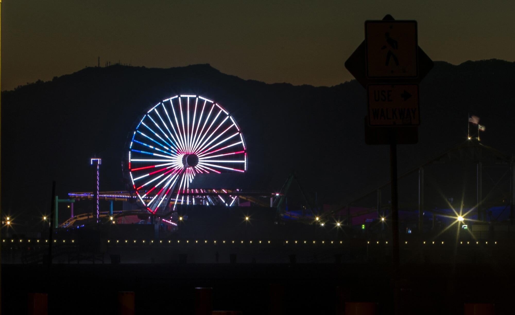 The Ferris wheel is lit in patriotic colors on July 4th weekend at the Santa Monica pier.