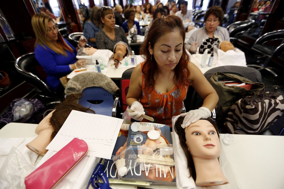 Emma Juarez Lopez of Los Angeles at a beautician school. She is in the country illegally but has obtained a state license as a cosmetology apprentice. A year-old state law allows such immigrants to get professional licenses as part of an effort to assimilate the newcomers.