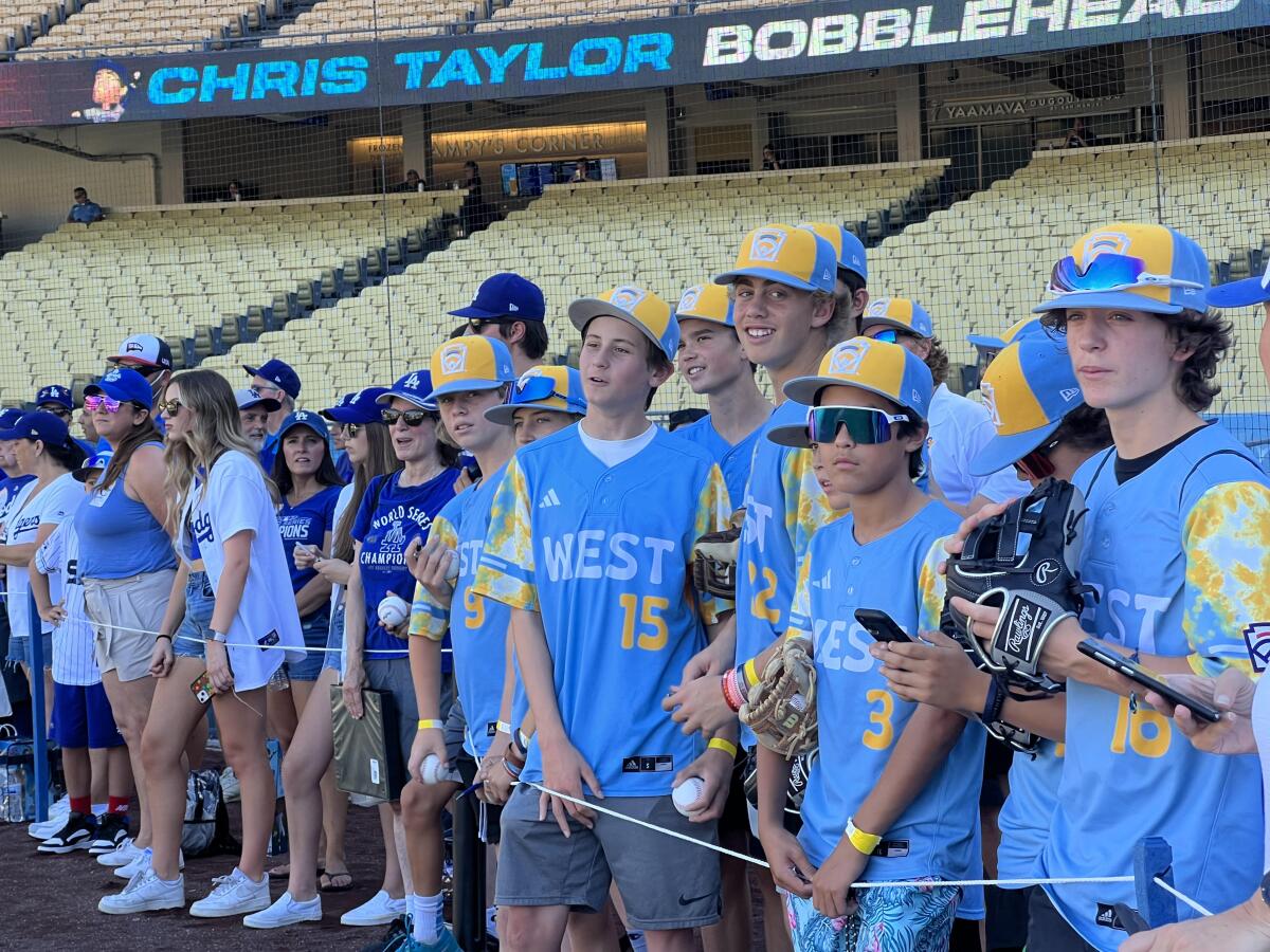 El Segundo Little League players watch batting practice before being recognized at Dodger Stadium.
