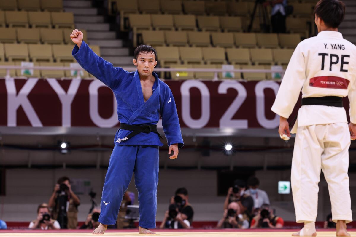 Naohisa Takato of Japan celebrates after winning judo gold