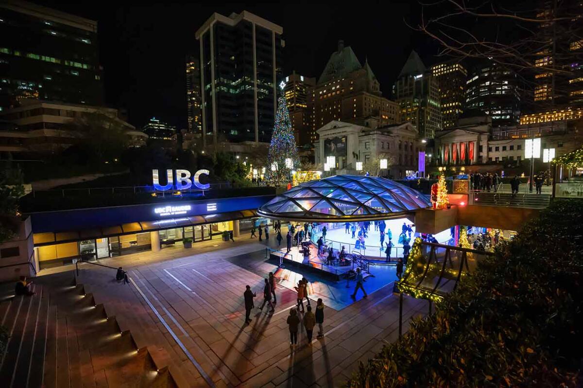 Downtown Vancouver, British Columbia, Canada: Crowd of people are ice skating in Robson Square during New Year's Eve.