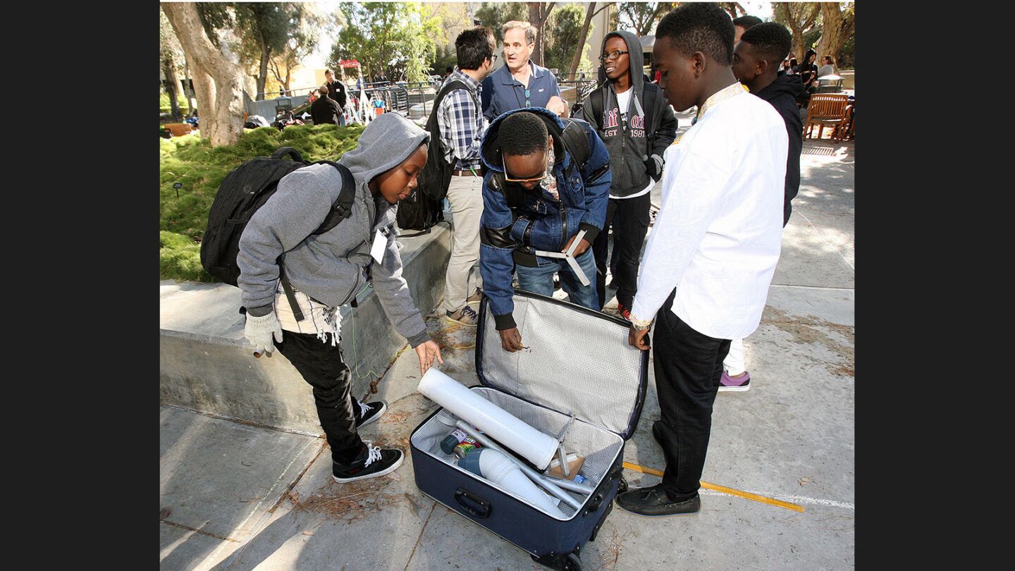 Francis Msuya, and Alfred Woiso, of Tanzania, put their invention back in the suitcase they travelled with to compete at JPL's annual Invention Challenge on Friday, December 2, 2016. 28 teams, including a team from Tanzania, but mostly of local Southern California schools, competed. The challenge was to transfer a specific amount of water over a distance to a collection cup on the other side. Methods included catapults, conveyor belts, a lot of duct tape, and pvc.