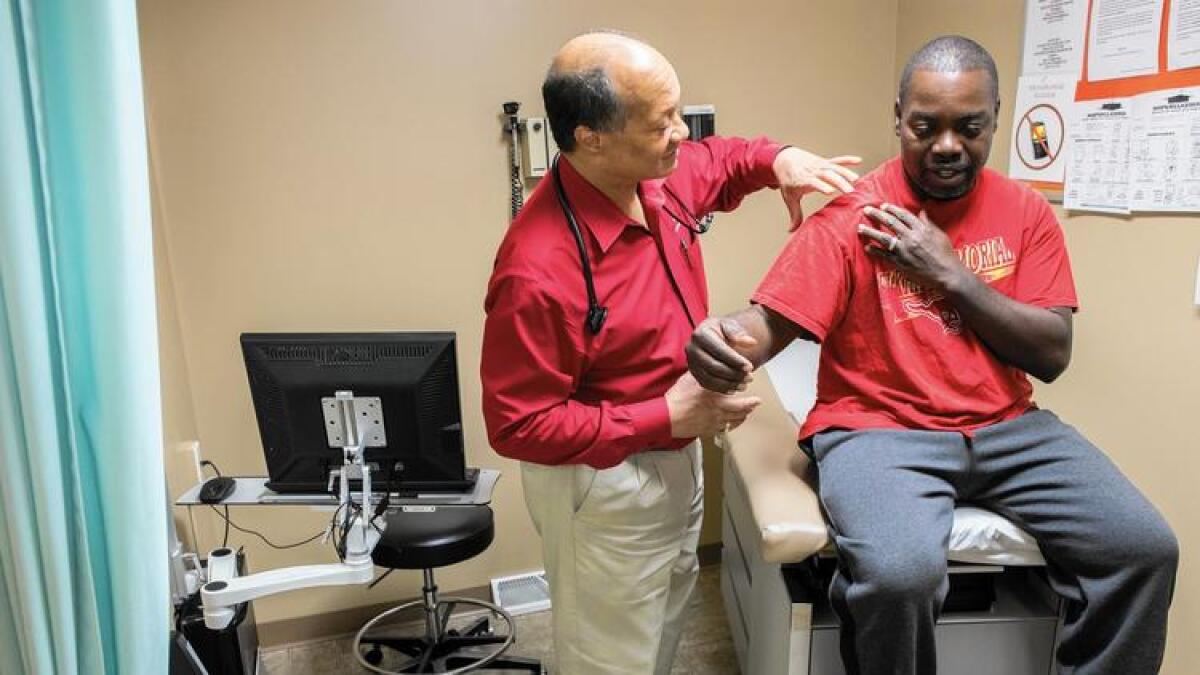 Dr. James Jackson performs a physical on Matthew Shorter, 51, a Medicaid patient enrolled in the Healthy Indiana Plan, at the Heart City Health Center in Elkhart, Ind.