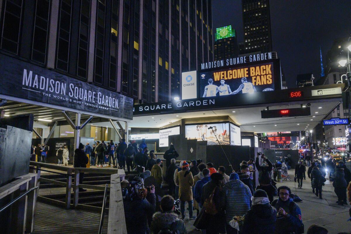FILE - Fans line up outside Madison Square Garden for an NBA basketball game between the New York Knicks and the Golden State Warriors in New York, Tuesday, Feb. 23, 2021. On Monday, Nov. 14, 2022, a judge granted a partial victory to a lawyer who sued Madison Square Garden after he and his colleagues were barred from the Garden and other MSG-owned venues because their firm represents a group suing the company. (AP Photo/Brittainy Newman, File)