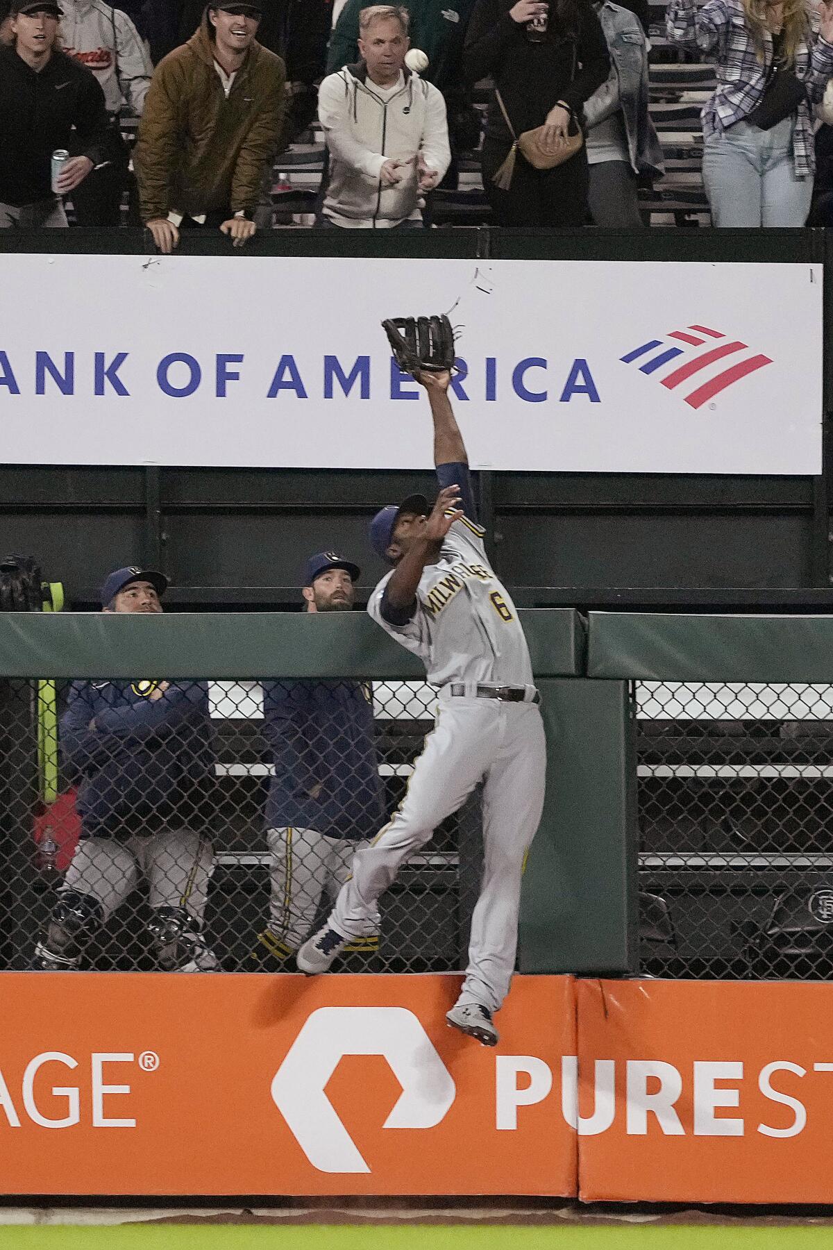 Milwaukee Brewers center fielder Lorenzo Cain leaps for but can't reach a solo home run by San Francisco Giants' Brandon Belt during the sixth inning of a baseball game Tuesday, Aug. 31, 2021, in San Francisco. (AP Photo/Tony Avelar)