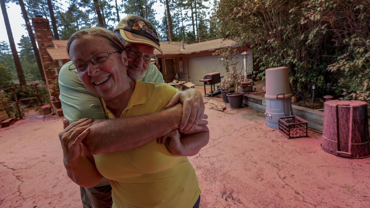 Steve and Suzanne Coffer have lived in their current Idyllwild home for 24 years. On Thursday morning, they found it covered in retardant, but safe.