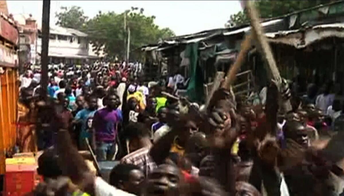 An image from a video released by TVC News shows residents after dozens of people were killed in twin bomb blasts at a market in the northeast Nigerian city of Maiduguri on Nov. 25.