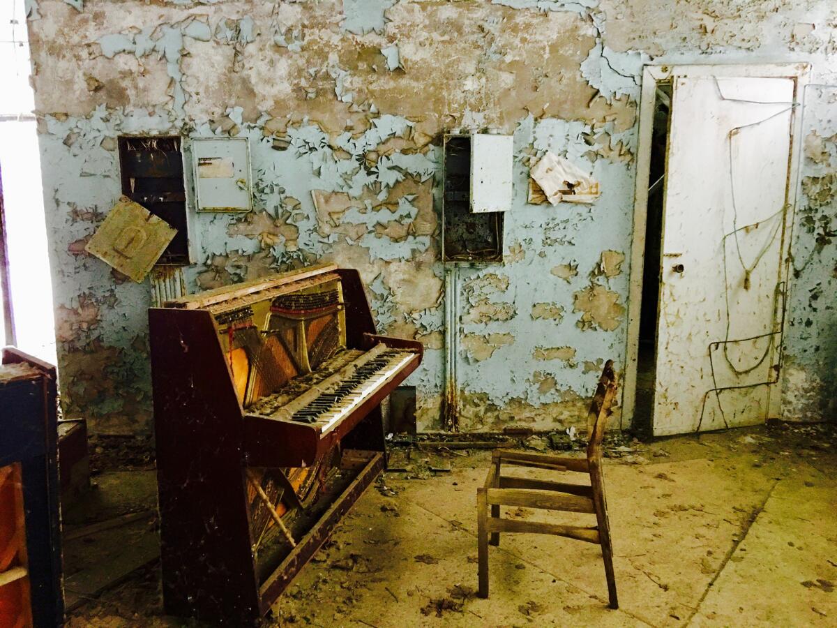 A decaying piano still stands in a store in the abandoned town of Pripyat, near Chernobyl.