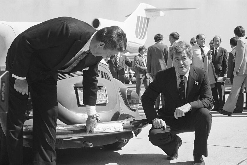 FILE - Republican presidential candidate Ronald Reagan, left, admires the bumper sticker on the car of Congressman Pete McCloskey as the congressman looks on, right, in San Jose, Calif., Sept. 25, 1980. Reagan was in the area on a campaign trip prior to leaving for more campaigning in Washington and Oregon. Former California Congressman McCloskey, who ran as a Republican challenging President Richard Nixon in 1972, has died at age 96. (AP Photo/Harrity, File)