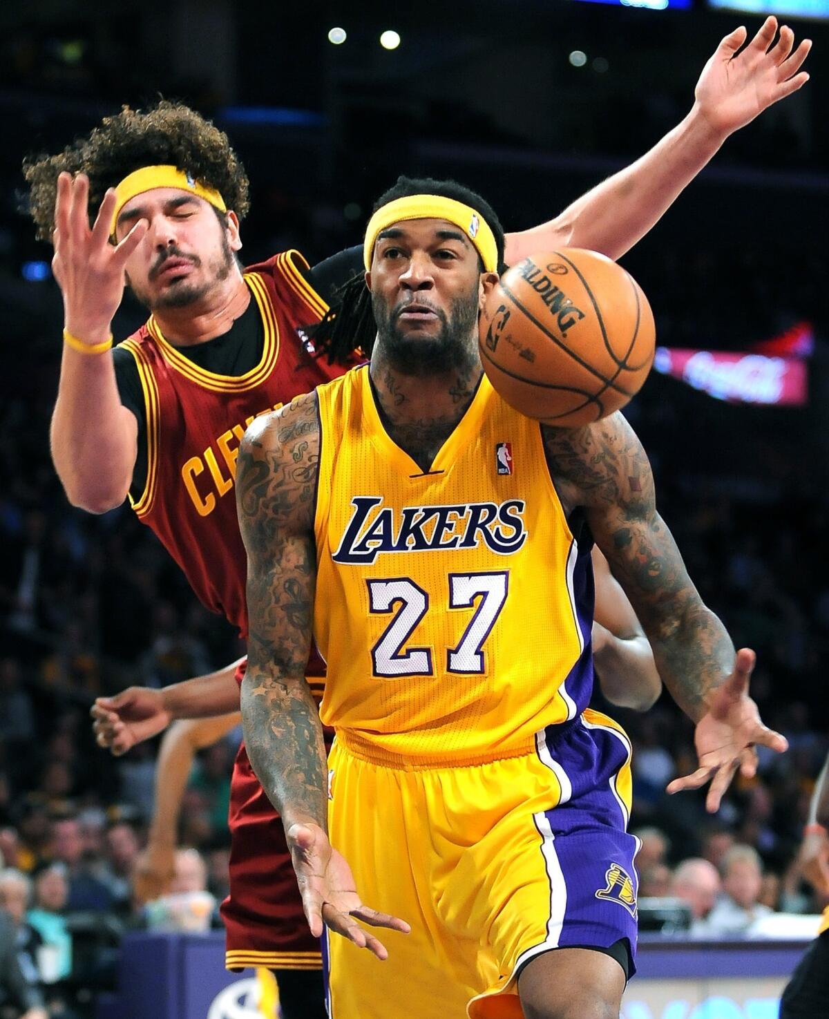 Jordan Hill and Cleveland's Anderson Varejao battle for a rebound during the first half Tuesday at Staples Center.