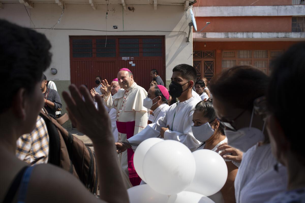 Monsignor Franco Coppola greets people as he arrives to meet families and celebrate Mass in Aguililla, Mexico.