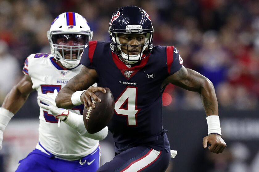 HOUSTON, TEXAS - JANUARY 04: Quarterback Deshaun Watson #4 of the Houston Texans scrambles against the defense of the Buffalo Bills during the AFC Wild Card Playoff game at NRG Stadium on January 04, 2020 in Houston, Texas. (Photo by Tim Warner/Getty Images)